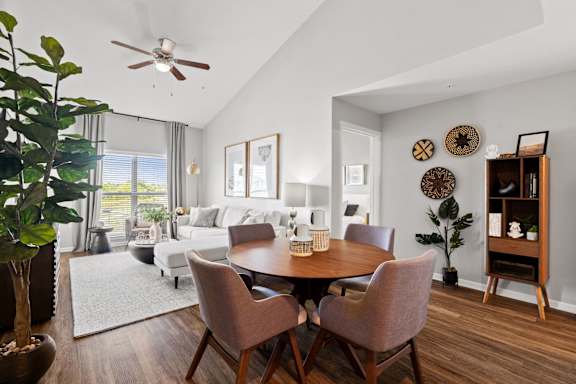 a living room with a dining room table and a couch