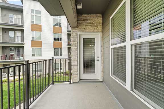 the outlook of the entrance to an apartment building with a balcony