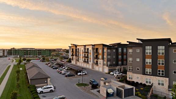 an aerial view of an apartment complex at sunset