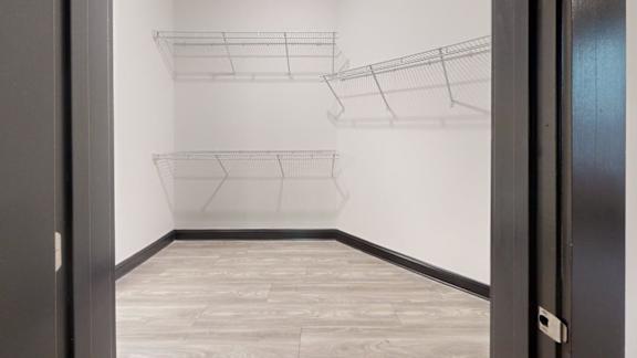A white wall with a black door and a black frame.
