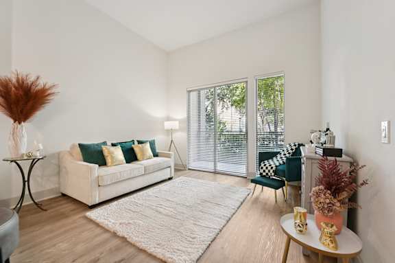 A living room with a white couch and a large window.