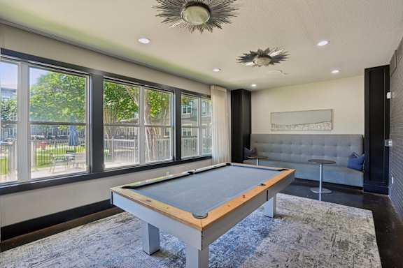 Billiards room with pool table and lounge seating at Highline Urban Lofts Apartments, Cypress, TX 77429