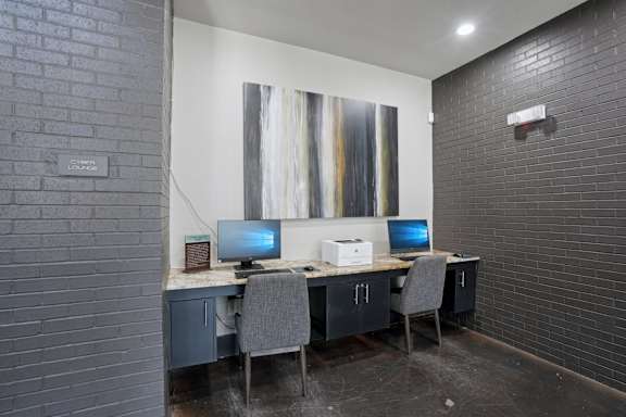 Business center with dual workstations and printer at Highline Urban Lofts Apartments, Cypress, TX