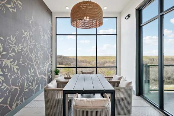 A modern dining room with a view of the outdoors.