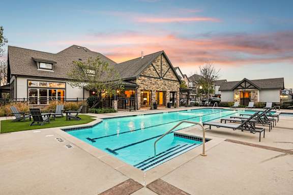 swimming pool with lounge area at Vine + Vail Townhomes and Apartments, Grapevine, TX