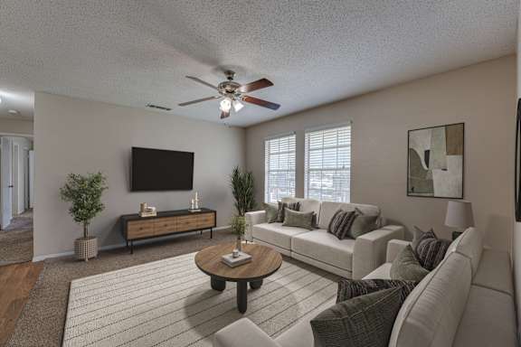 A living room with a couch, a coffee table, and a television.