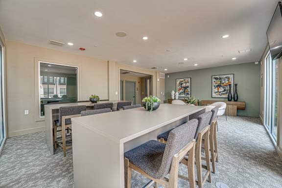 Community room with high top seating and lounge area at The Barton Apartments, Texas