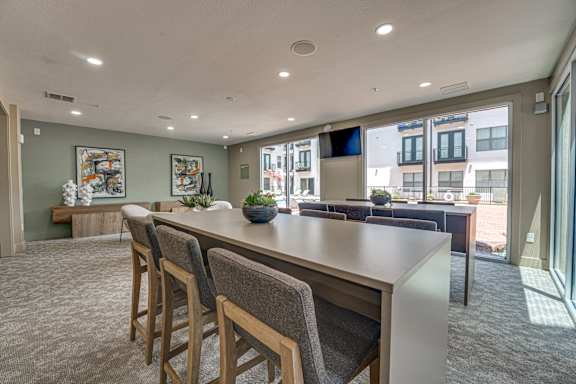 Resident lounge with community bar and outdoor terrace at The Barton Apartments, Texas, 75206