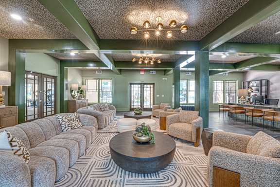 A large, well-lit room with a long couch and a coffee table in the center.