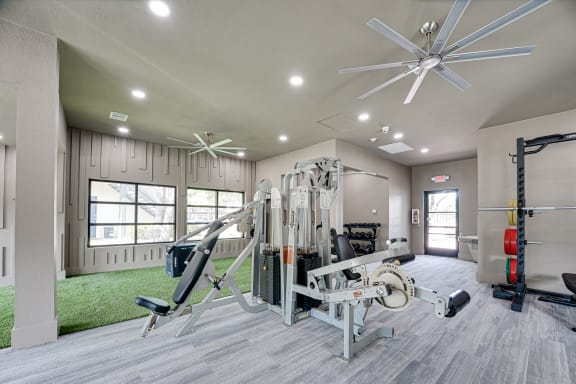 Fitness center with multi station weight machine at Carmel Creekside Apartments, Fort Worth