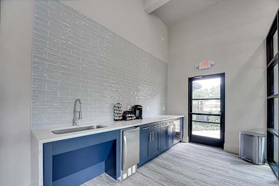 Kitchenette with blue cabinets and white countertops at Carmel Creekside Apartments, Fort Worth, 76137