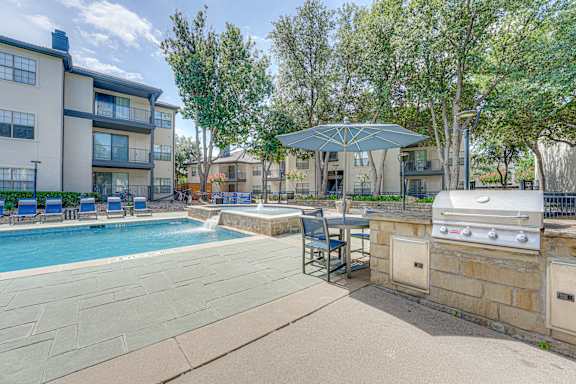 Poolside grilling station with built in barbecue at Carmel Creekside Apartments, Fort Worth, TX 76137