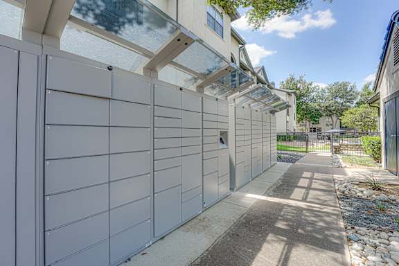 Package locker system with covered walkway at Carmel Creekside Apartments, Fort Worth, Texas