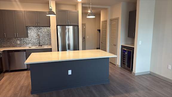 A kitchen with a large island in the middle.