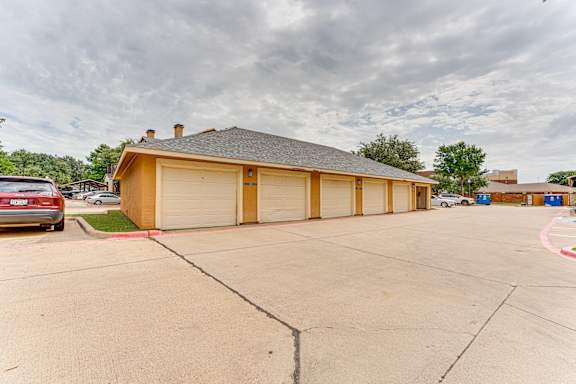 Detached garage building with multiple doors at Limestone Ranch Apartments, Lewisville, Texas