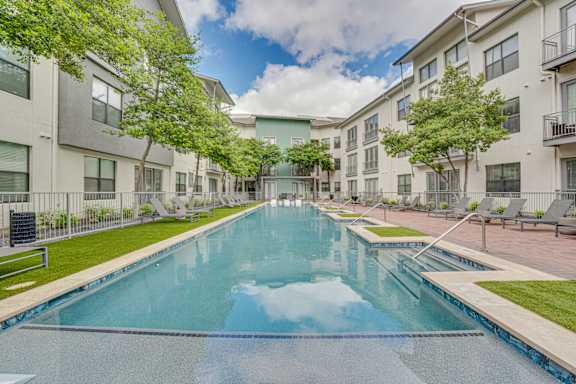 Swimming pool surrounded by modern apartment buildings at The Montrose Apartments, Texas, 75204