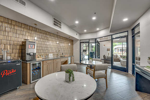 Coffee bar and lounge with seating and patio access at The Montrose Apartments, Dallas, 75204