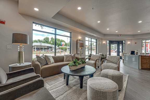 Clubhouse lounge with modern seating and large windows at The Montrose Apartments, Dallas, Texas