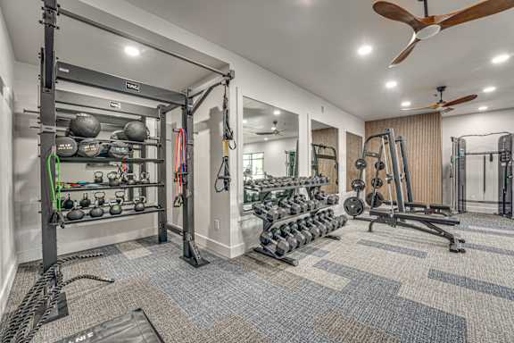 Fitness center with weight equipment and workout machines at The Montrose Apartments, Dallas, TX