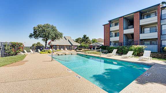 pool in front of White brown building at Paces Crossing, Texas, 76210