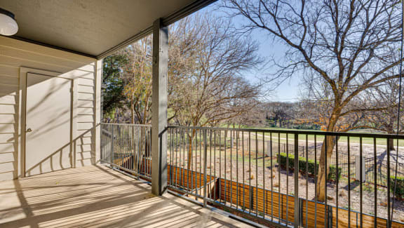 Private balcony overlooking park and open green space at Carmel Creekside Apartments, Texas, 76137
