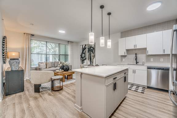 Open kitchen with white island at The Barton Apartments, Dallas