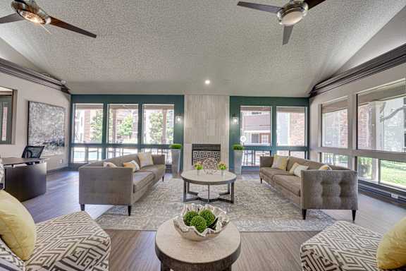 living room with two ceiling fan at Timberglen Apartments, Dallas Texas