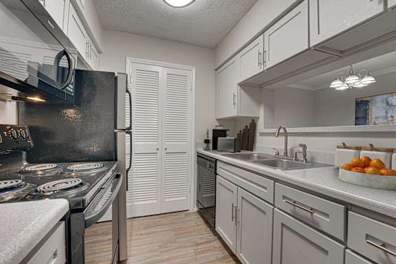 kitchen with a black stove at Timberglen Apartments, Dallas, TX 75287