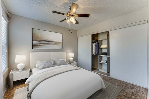 Bedroom with walk-in closet and ceiling fan at Towne Centre Village Apartments, Texas, 75150