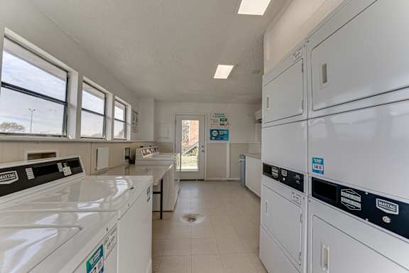 Community laundry room with washers and dryers at Towne Centre Village Apartments, Mesquite, Texas