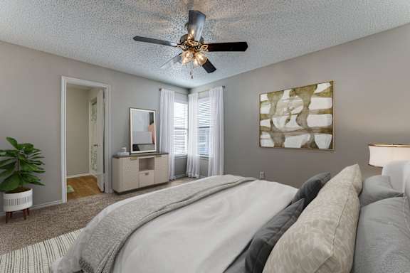 Bedroom with ceiling fan and neutral decor at Towne Centre Village Apartments, Texas, 75150