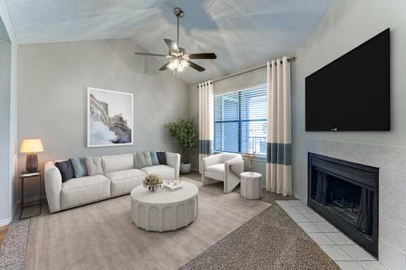 Living room with fireplace and neutral furnishings at Towne Centre Village Apartments, Mesquite, TX 75150