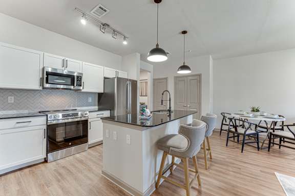 kitchen with dining table at Vine + Vail Townhomes and Apartments, Grapevine
