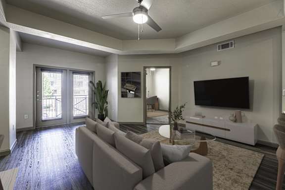 A living room with a grey sofa and a television.