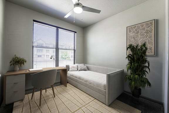 A room with a bed, desk, and chair.