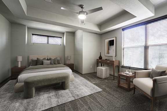 A bedroom with a bed, chair, and table.