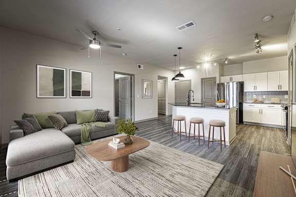 A modern living room with a grey sofa and a wooden coffee table.