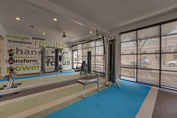 Fitness center with weight equipment and large windows at Vue Live Oak Apartments, Texas, 75204