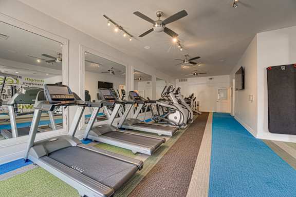 Fitness center with cardio equipment at Vue Live Oak Apartments, Dallas, TX 75204
