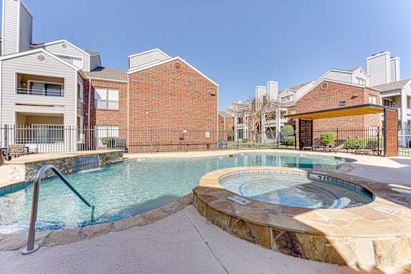 A swimming pool with a hot tub in the middle of it at Wilson Crossing, Cedar Hill, TX, 75104