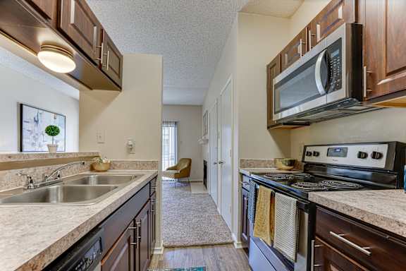 A kitchen with a stove, sink, and microwave. at Wilson Crossing, Cedar Hill