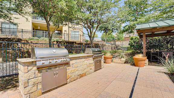 backyard with a stone wall at Wind Dance, Carrollton, TX