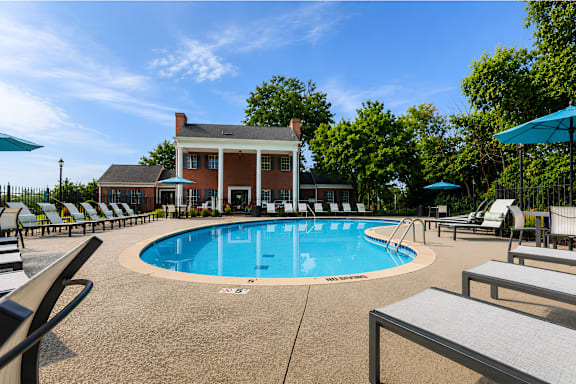 A pool with a building behind it.