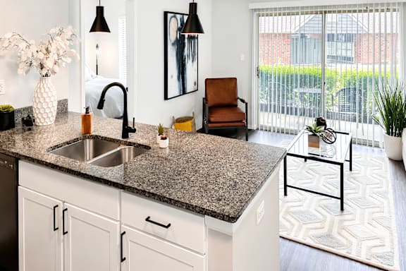 A kitchen with a granite countertop and a sink.