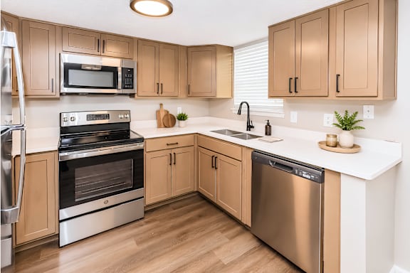 A kitchen with wooden cabinets and stainless steel appliances.
