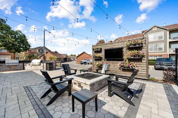 A patio with a table and chairs is set up for outdoor dining.