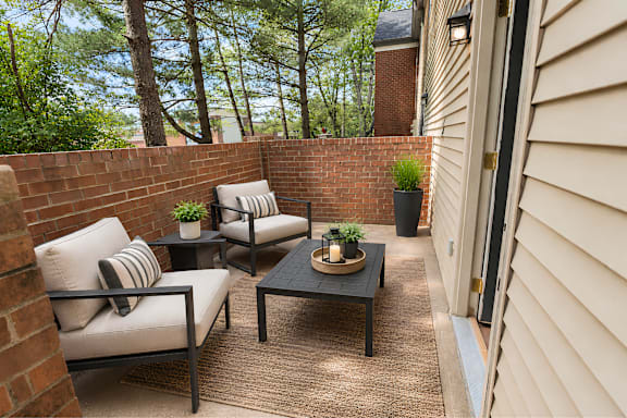 A patio with a table and chairs.