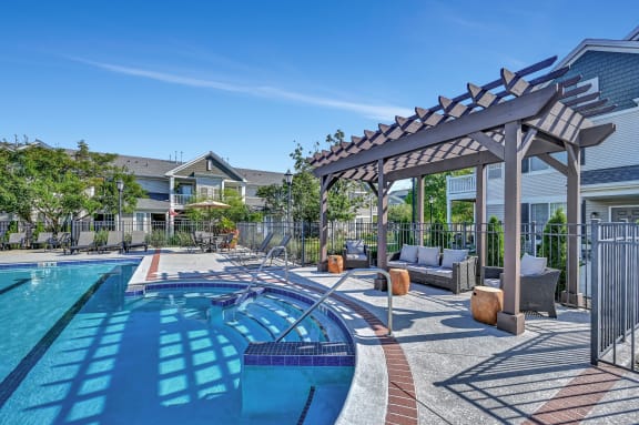 pergola next to a large swimming pool at Farmington Lakes Apartments in Oswego