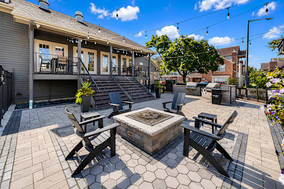 A patio with a fire pit and seating area.