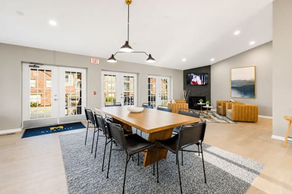 A dining room with a long table and chairs.